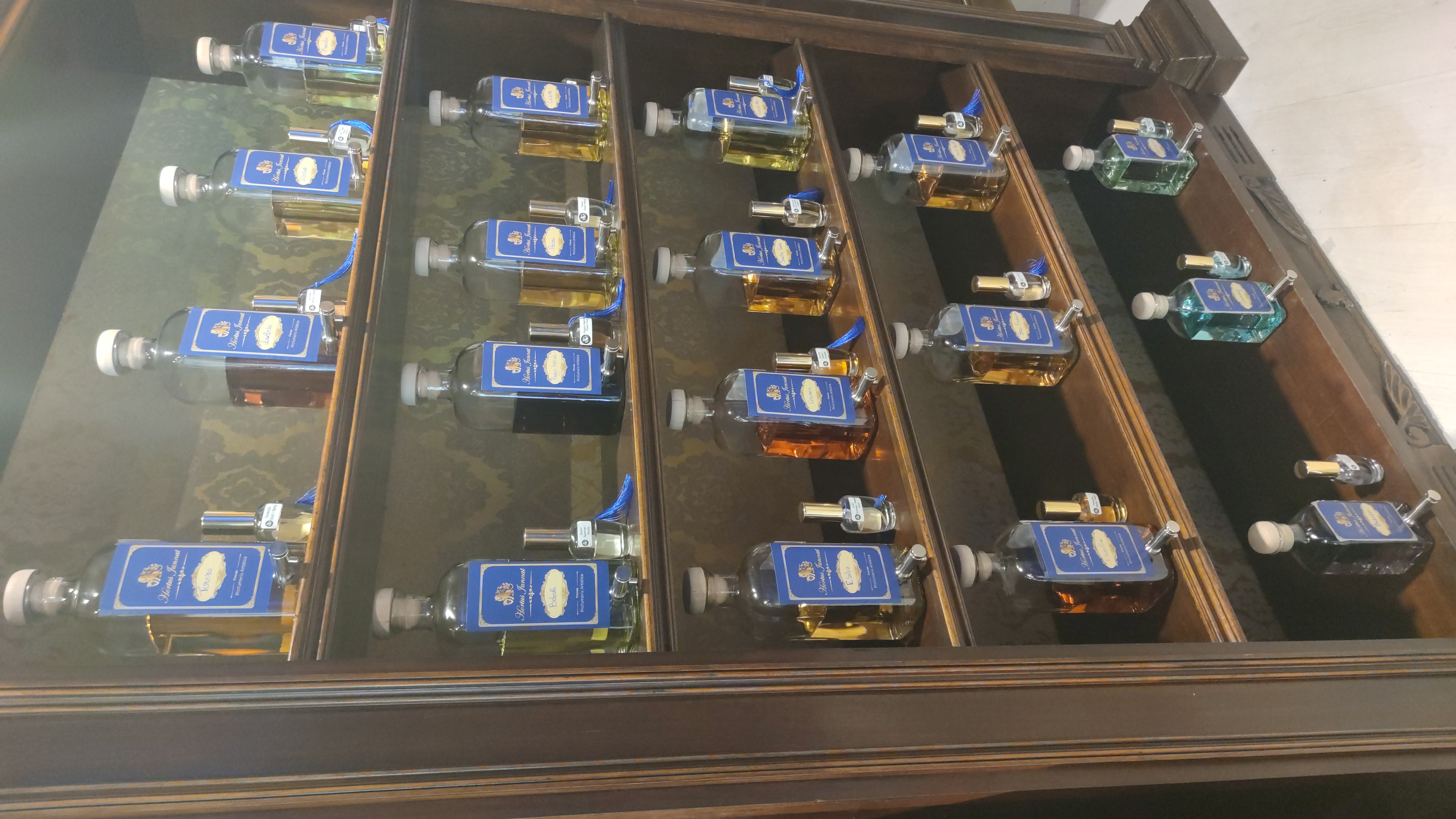 Hortus Jannat perfume collection on wooden shelves